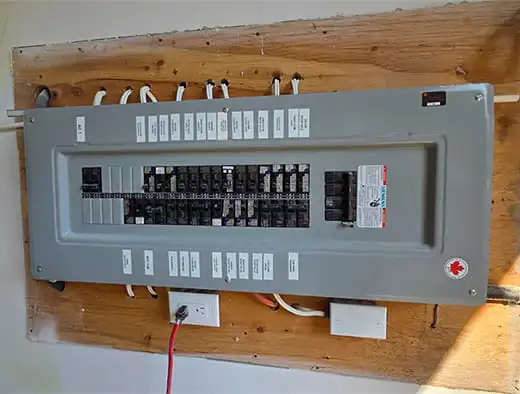 Siemens electrical panel mounted on a plywood sheet on a wall
